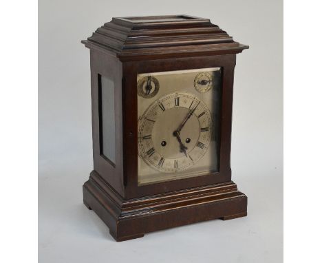 An early 20th century walnut cased eight-day mantel clock with silvered dial incorporating a subsidiary strike/silent and fas