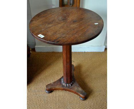 A Victorian rosewood occasional table, the circular top raised on an octagonal pillar to a shaped tri-form base