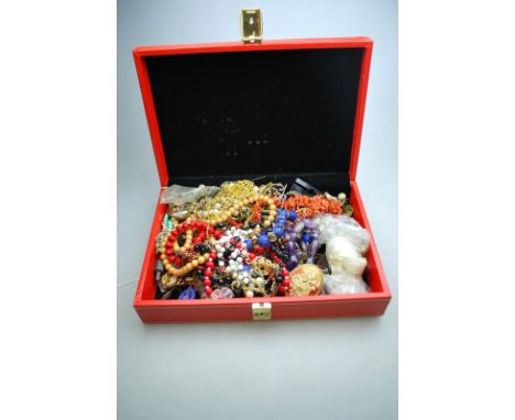 A jewel box containing a quantity of vintage and later costume jewellery including stick coral necklace, horse and rider cuff