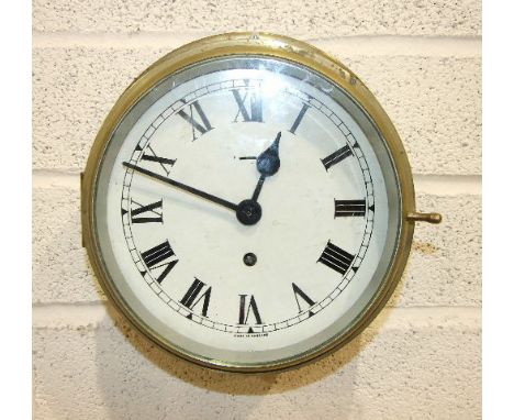 An Elliott Ltd brass ships bulkhead clock, the 20cm dial with Roman numerals and F/W, stencil to back broad arrow 6645.99.129