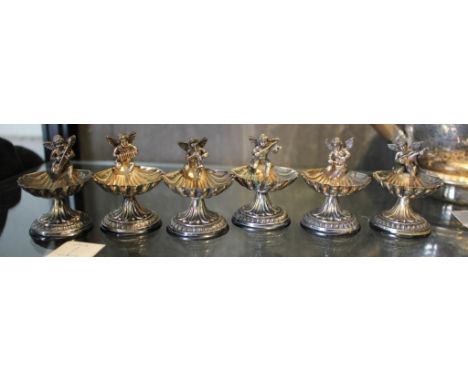 Six silver plated miniature mustards, in the form of a shell surmounted by a putti playing a musical instrument 