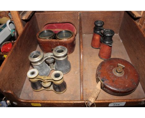 A pair of mother of pearl and brass opera glasses, three other pairs and a 66ft fabric tape measure in leather case by Hockle