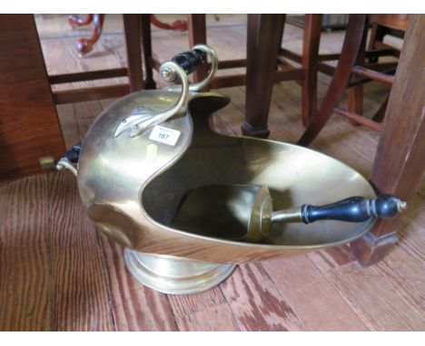 A brass coal helmet, with turned ebony handles and shovel