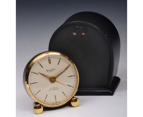 A TRAVEL CLOCK BY MOBEC, of circular form with reeded black enamel decoration, the signed silvered dial with baton markers an