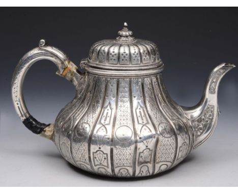 A VICTORIAN SILVER TEAPOT with fluted panelled sides and chased geometric decoration, matching domed lid and handle, 17cm hig