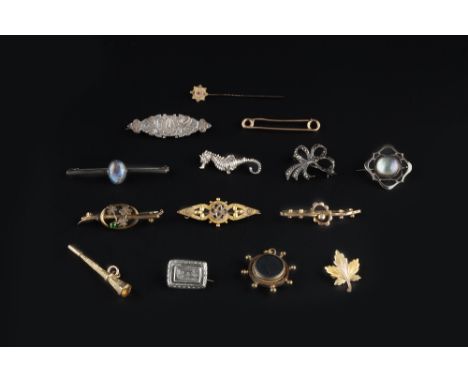 A COLLECTION OF JEWELLERY, comprising a two colour precious metal leaf brooch, stamped '10k', four panel brooches, seven furt