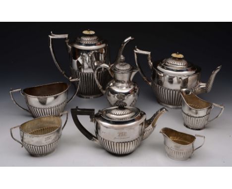 A SILVER THREEPIECE TEA SET, oval shaped with fluted lower body, ebonised handle and matching finial, with matching sugar bas