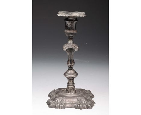 A GEORGE II SILVER CANDLESTICK with a square shaped base in the form of scallop shells, matching knop and drip pan, 20cm high