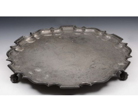 A LARGE SILVER SALVER with a Chippendale style border and standing on three scrolled legs, 46cm diameter, London 1910 by Thom