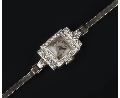 A DIAMOND COCKTAIL WATCH, of Art Deco design, the rectangular silvered dial with Arabic numerals and outer minute scale, to a