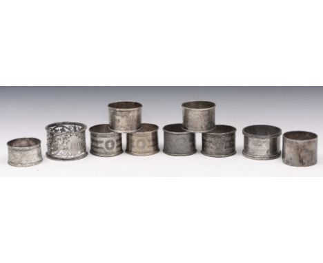 A SET OF SIX SILVER NAPKIN RINGS with engine turned decoration, Birmingham 1913 by Gorham Manufacturing Co.; and four further