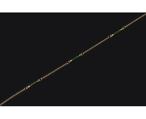 AN 18CT GOLD AND ENAMEL NECKLACE, the trace-link chain spaced by eight batons, each highlighted with green enamel decoration,