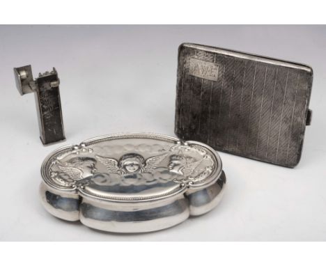 AN OVAL SILVER SHAPED TRINKET BOX with shaped sides and with pressed cherub decoration, 23cm long, Chester 1898; a silver cig