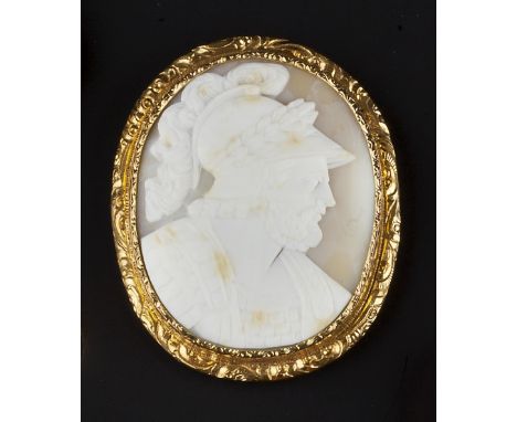 A VICTORIAN OVAL SHELL CAMEO BROOCH, carved to depict the portrait profile of a classical bearded male warrior, wearing armou
