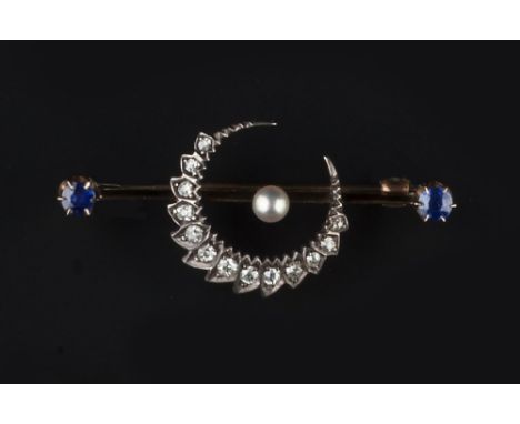 A SAPPHIRE AND DIAMOND SET CRESCENT BAR BROOCH, the knife-edge bar with central old-cut diamond set crescent moon, highlighte