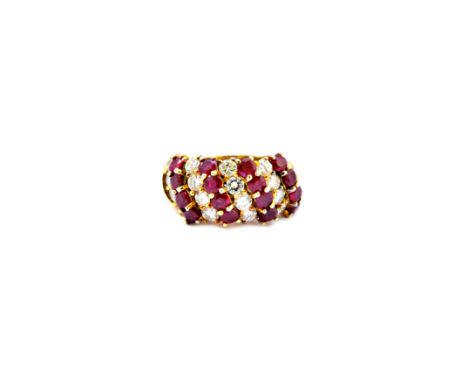 A gold, ruby and diamond set ring, mounted with four rows of four circular cut rubies, alternating with four rows of four cir