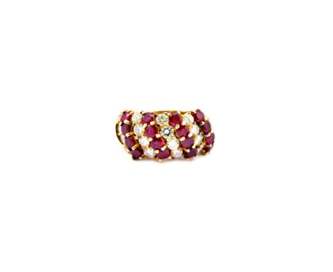 A gold, ruby and diamond set ring, mounted with four rows of four circular cut rubies, alternating with four rows of four cir