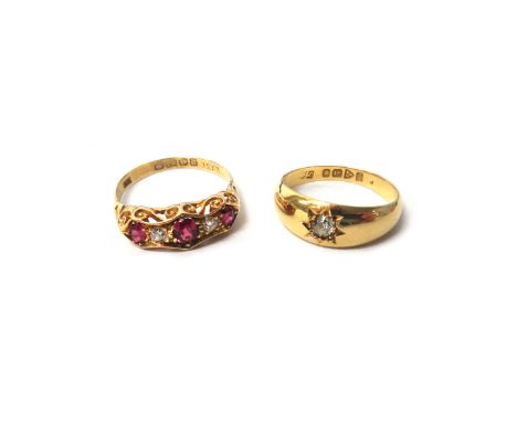 An 18ct gold ring, star gypsy set with a cushion shaped diamond, Chester 1916, ring size O and a half and an 18ct gold, ruby 