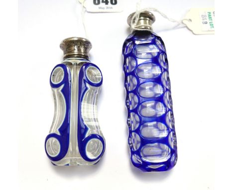 A Victorian blue flashed cut glass scent bottle with white metal screw cap, 11.2cm, and a blue and white enamel overlaid cut 