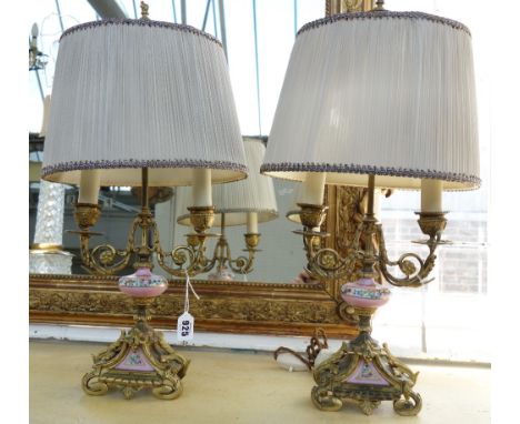 A pair of Louis Philippe Sevres style porcelain and ormolu two light candelabra, the stem with rose pompadour over a triform 