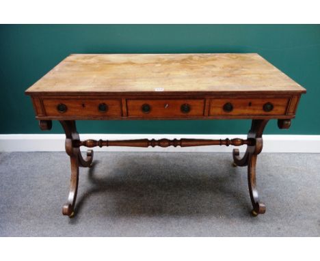 A Regency mahogany sofa table, with three frieze drawers and dummy verso, on 'X' framed trestle supports, united by turned st