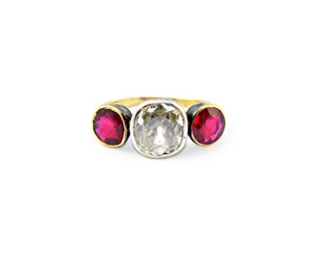 A diamond and synthetic ruby set three stone ring, mounted with the cushion shaped diamond at the centre, size of diamond app