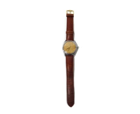 A gentleman's circular steel cased Omega wristwatch, the signed circular dial with gilt Arabic and arrow shaped numerals, tap
