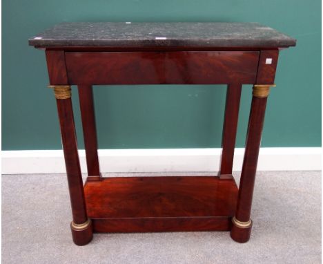 An Empire gilt metal mounted console, the black marble top over flush fit frieze drawer, on a pair of turned columns, united 
