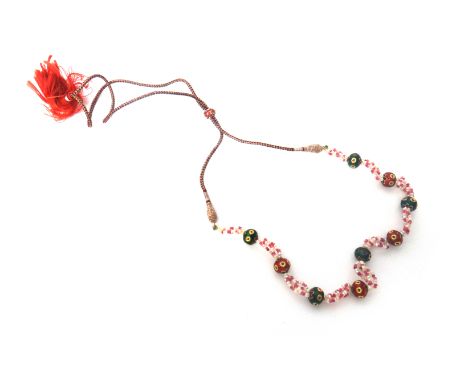 An Indian seed pearl, ruby bead and enamelled necklace, probably Indian, in a four row seed pearl and ruby bead design, space