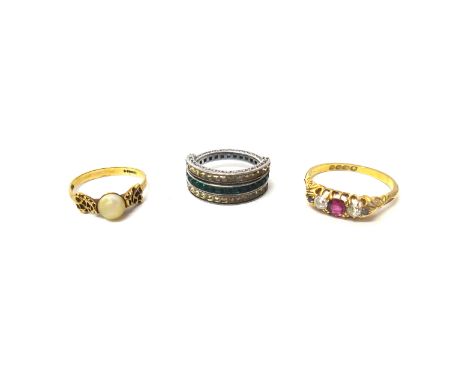 An 18ct gold, ruby and diamond set ring, mounted with the cushion shaped ruby at the centre, between two cushion shaped diamo