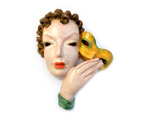 A Goldscheider pottery wall mask, 1930's, depicting an Art Deco female bust holding a yellow mask, indistinctly marked, 28cm 