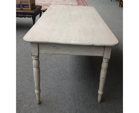 An early 19th century later grey painted pine kitchen table, with rounded rectangular plank top on tapering turned supports, 