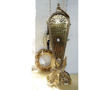 A brass folding fire screen, 62cm high, together with a pair of Italian Florentine giltwood carved circular picture frames an