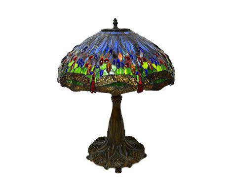 A bronze and coloured glass Tiffany style table lamp, late 20th century, with a dragonfly shade over a body cast with pierced