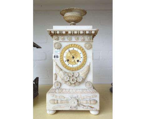 An alabaster and parcel gilt mantel clock, late 19th century, with all over foliate carved embellishments and an urn finial, 