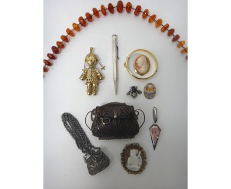 A silver gilt and gem set pendant, designed as a doll, two oval shell cameo brooches, two further silver brooches, a single r