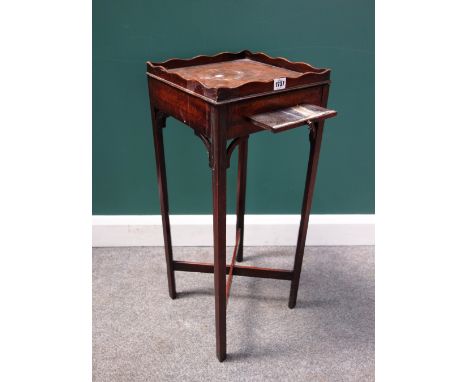 A George III mahogany kettle stand with galleried square top and pull-out candle slide, on tapering square supports, 32cm wid