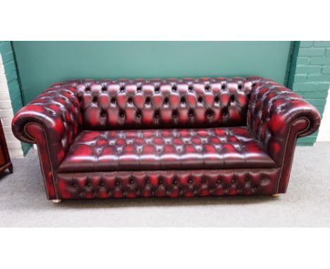 A 20th century red leather button upholstered Chesterfield sofa, with studded decoration, 198cm wide.