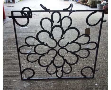 A blacksmith made garden chair, a rectangular planter, a screen and a small stand, all constructed out of black painted inter