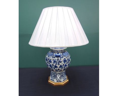 A Dutch Delft style pottery vase and cover, 20th century, adapted to a table lamp with a pleated shade, 44cm high. 