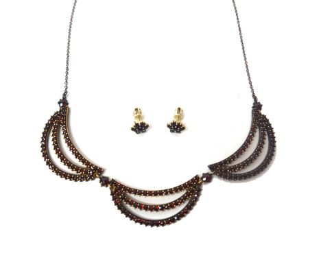 A Bohemian garnet set necklace, in a triple three row crescent shaped link design, on a boltring clasp and a pair of Bohemian