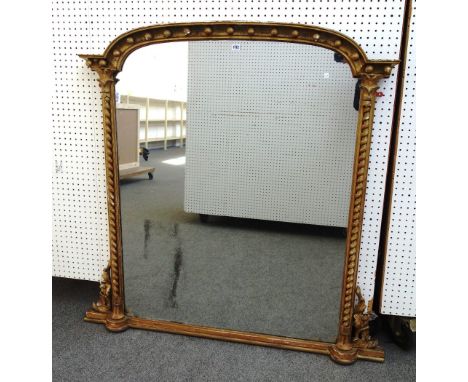 A Victorian gilt framed over mantel mirror, with ball mounted arch top and flanking barley twist columns, 139cm wide x 135cm 