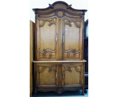 A 19th century French oak buffet deux corps, the arch cornice over a pair of shaped panel doors, on scroll feet, 147cm wide x