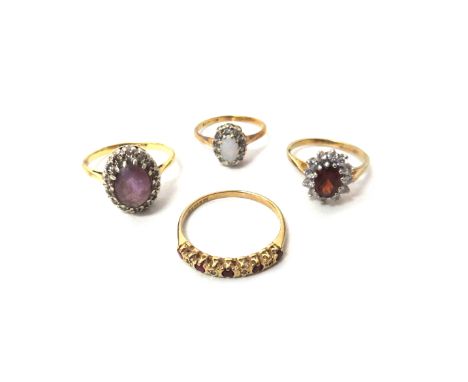 A 9ct gold, opal and diamond set oval cluster ring, a gold, amethyst and diamond set oval cluster ring, a 9ct gold, ruby and 