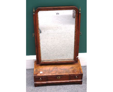 An 18th century parcel gilt figured walnut toilet mirror, with cushion three drawer base, on bracket feet, 40cm wide, togethe