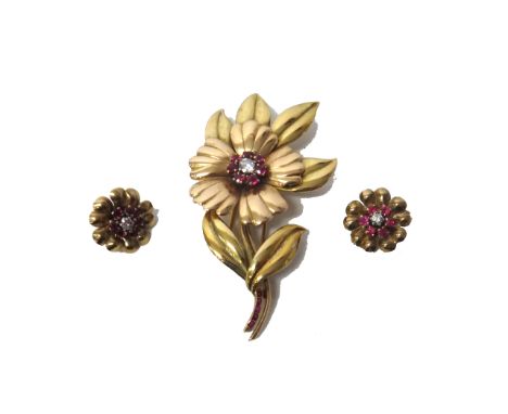 A two colour gold, ruby and diamond set brooch, designed as a flower spray, mounted with the principal circular cut diamond a