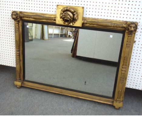 A 19th century gilt framed rectangular wall mirror, with floral carved crest above the rectangular mirror plate, the frame wi