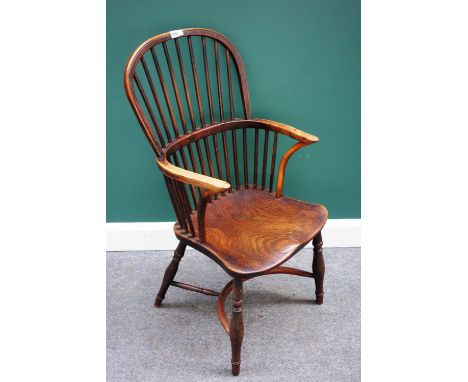 A George III yew and elm stick back Windsor chair, on turned supports, united by a crinoline stretcher.