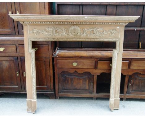 An 18th century style pine fire surround, with shell and acanthus scroll frieze, 160cm wide x 137cm high, the aperture 115cm 