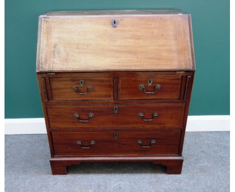 A George III mahogany bureau, the fall enclosing a fitted interior, over two short and two long drawers, on bracket feet, 84c